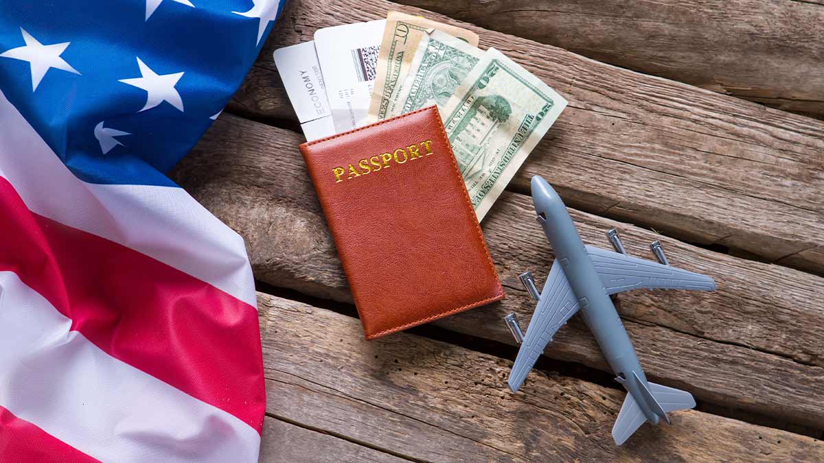 Usa flag and passport with some money on a wooden bench