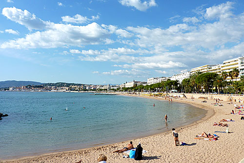 Cannes beach, sand, with people swimming