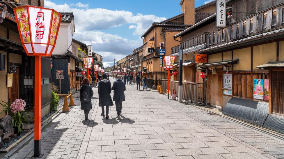 Three people walking in the clean streets of japan