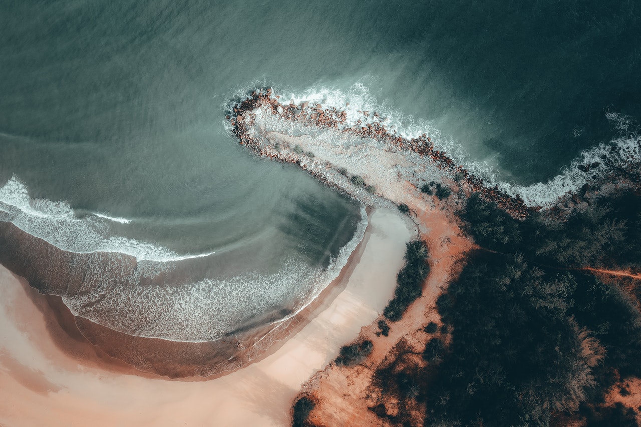 Aerial View of Crashing Waves on the Shore