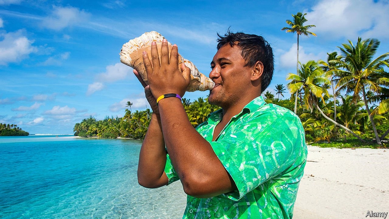 A Cook islander blowing a seashell horn at the beach side