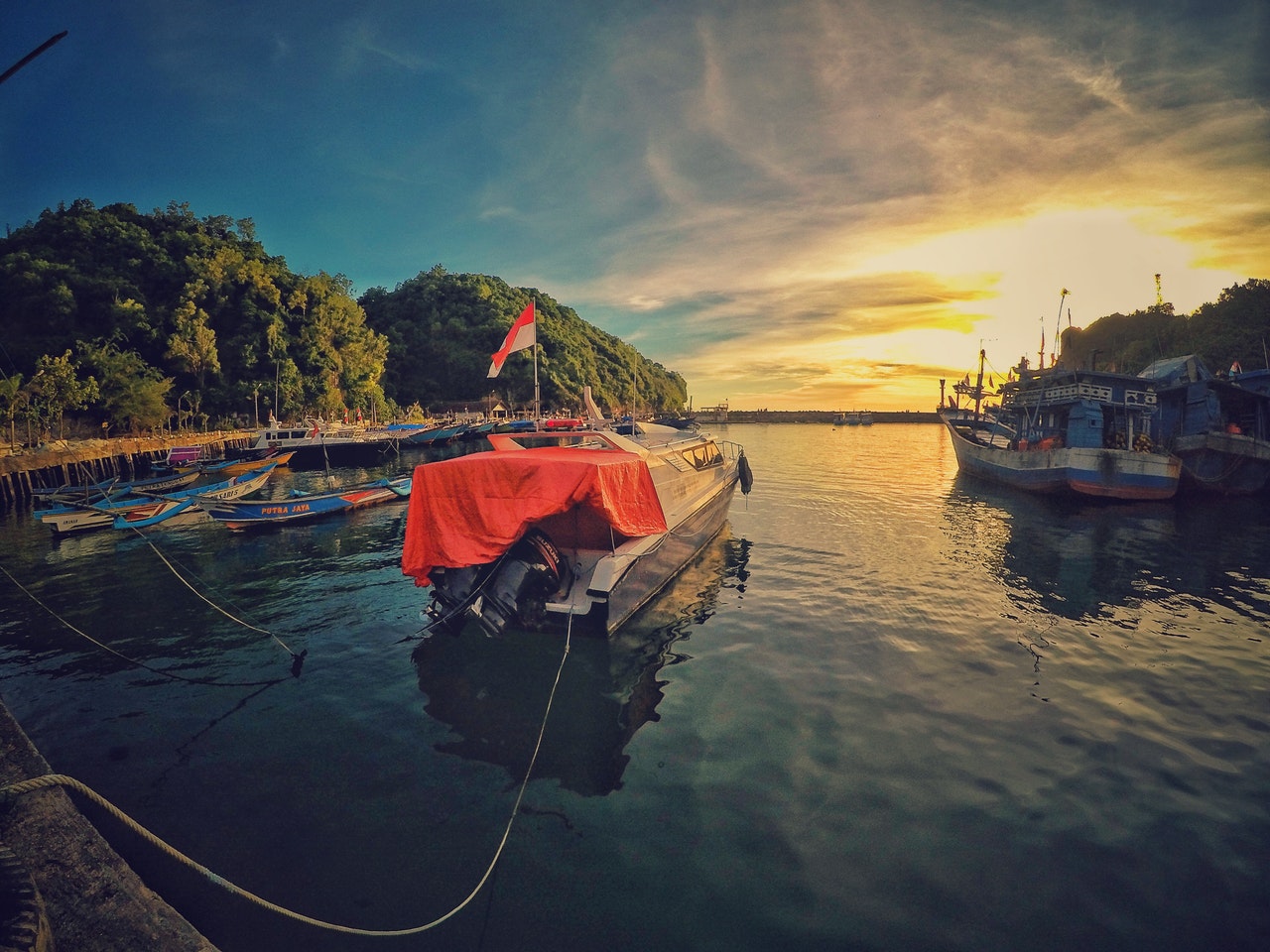 Motor Boat Near Dock during Sunset at Baliem Valley
