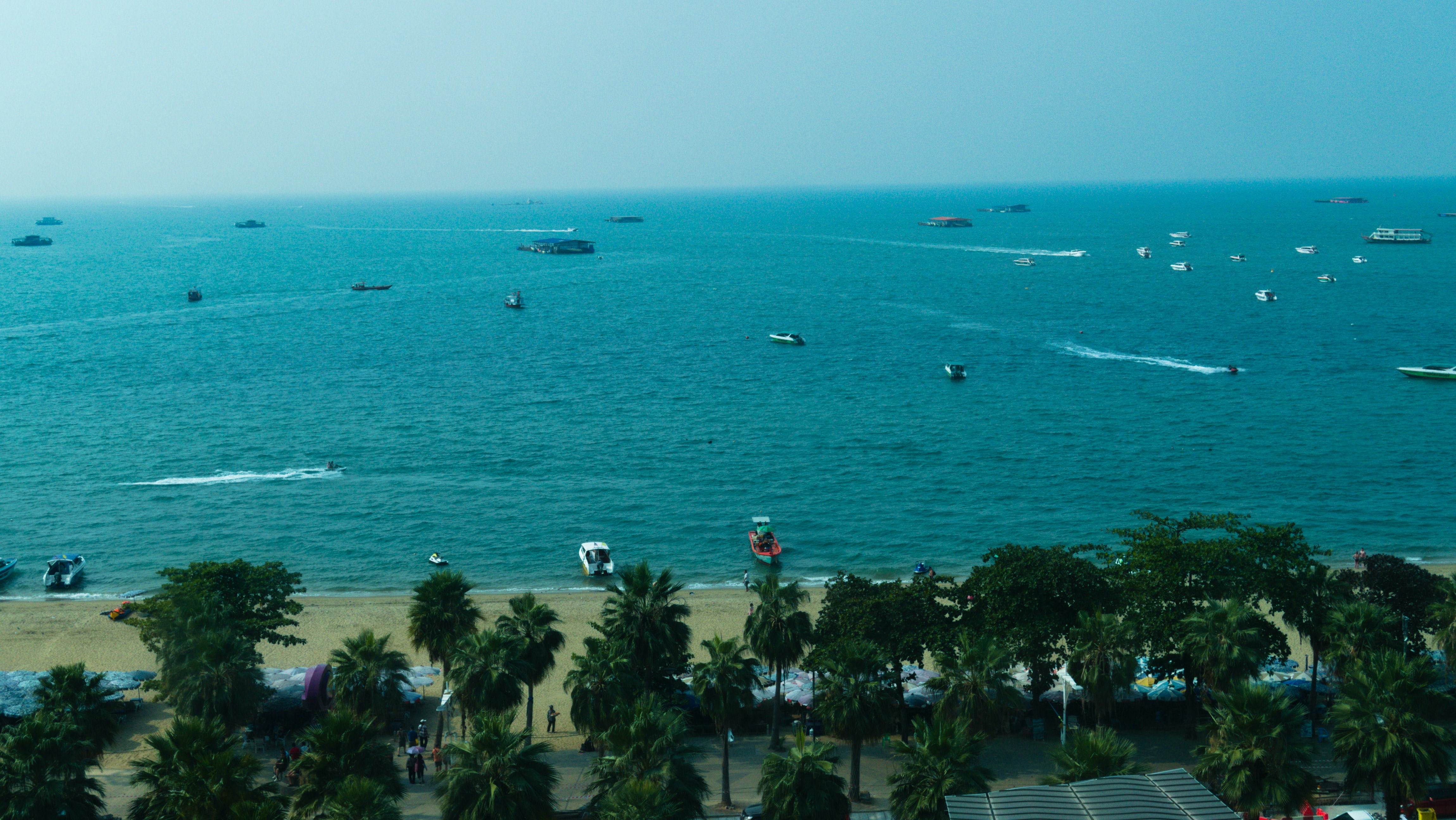 Eagle's eye view of Pattaya Beach with different sizes of ships and boats on the water