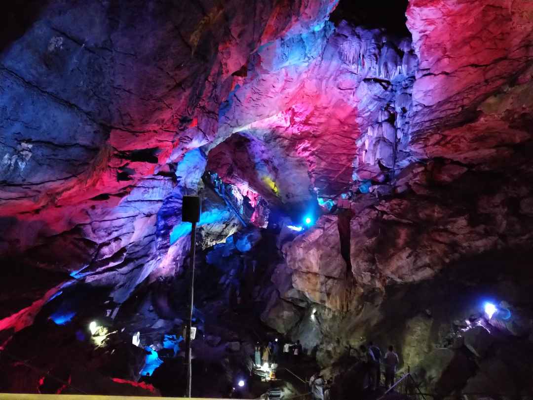 Borra Caves with lights and tourists inside the cave