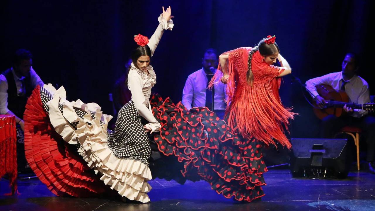 Two dancers wearing flamenco traditional dress in flamenco theatre barcelona city hall