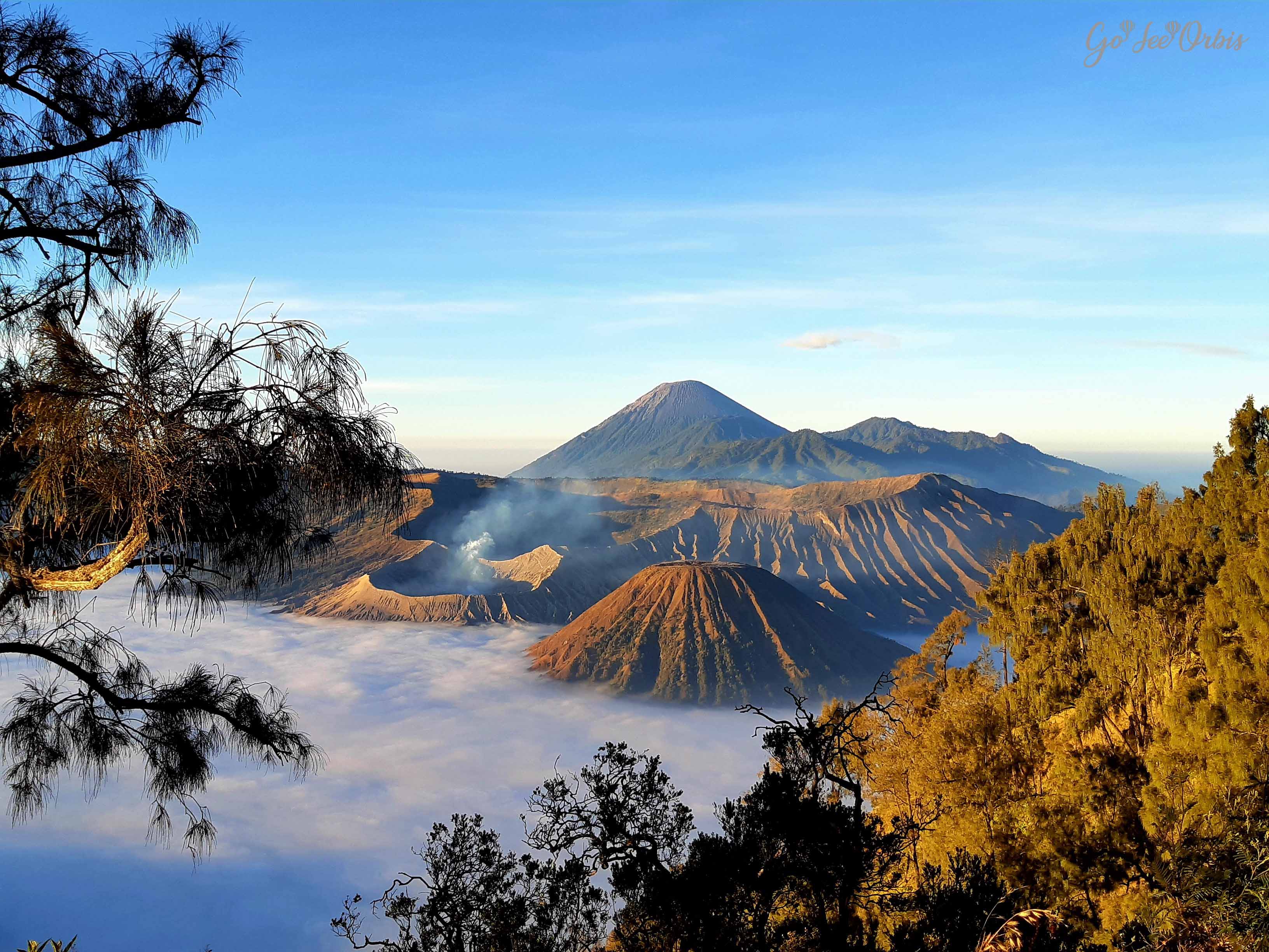 An aerial view of Mount Bromo with some parts covered in clouds