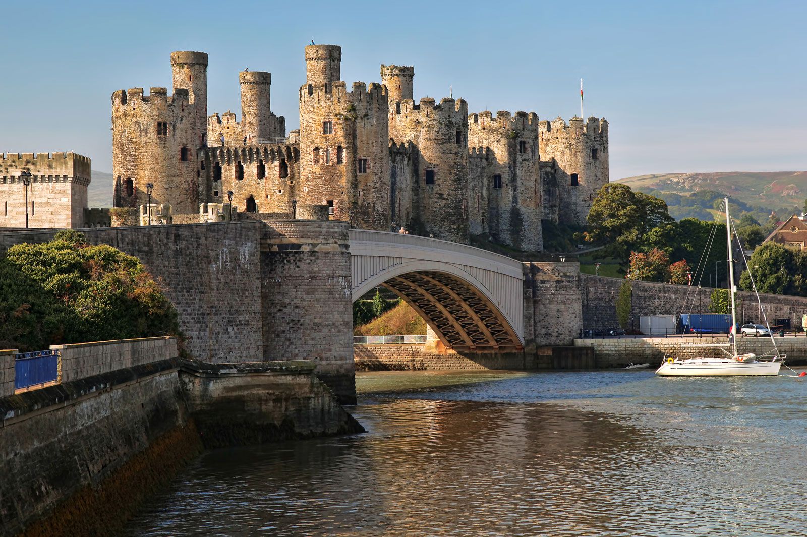 Giant brown bricked Conwy castle above the  river in the  wales