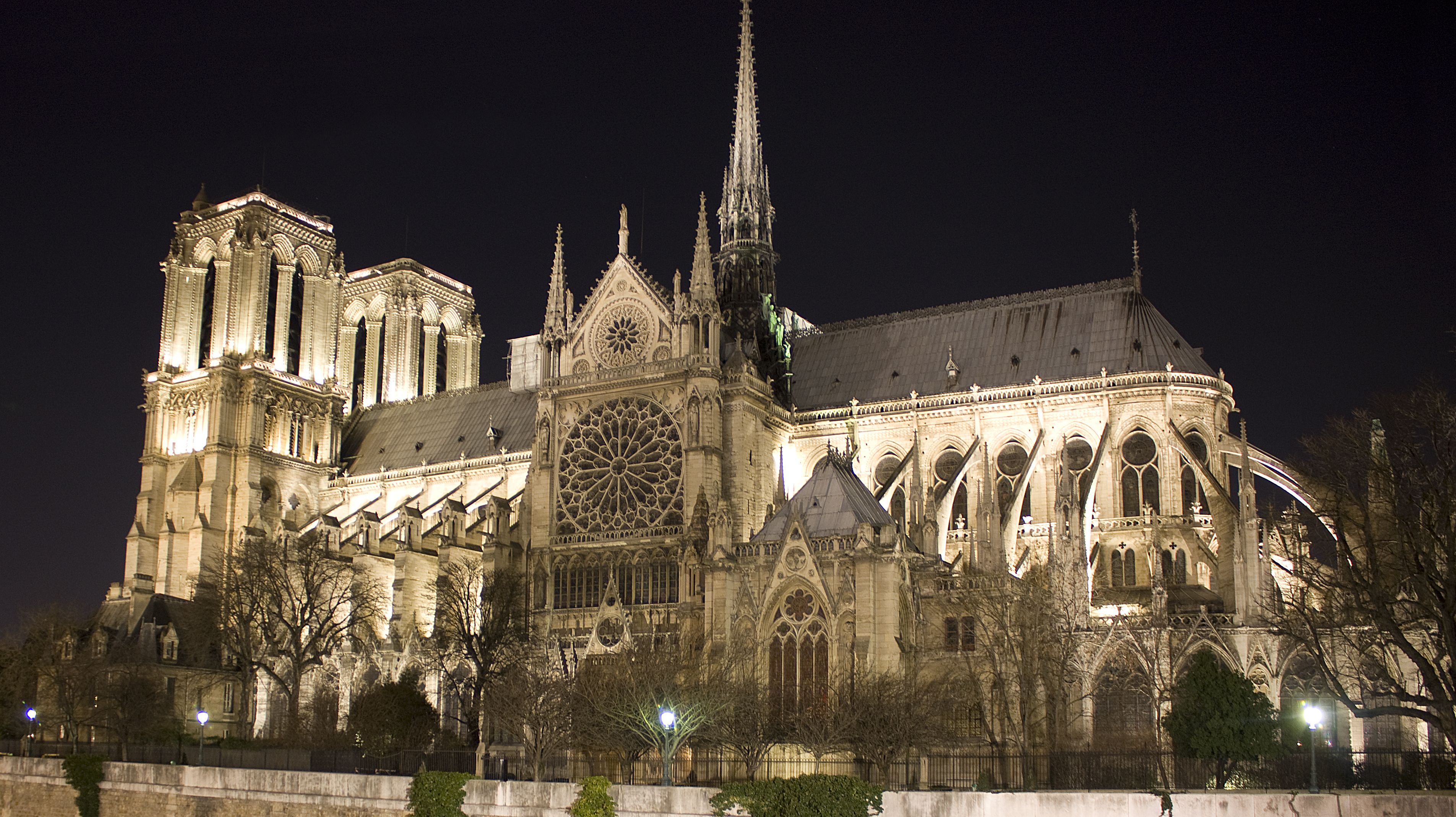 A view of Notre-Dame de Paris in France with lights during evening time