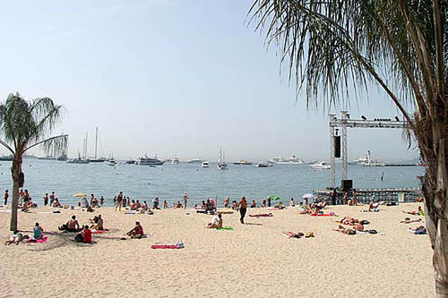 Cannes beach with people sunbathing and swimming