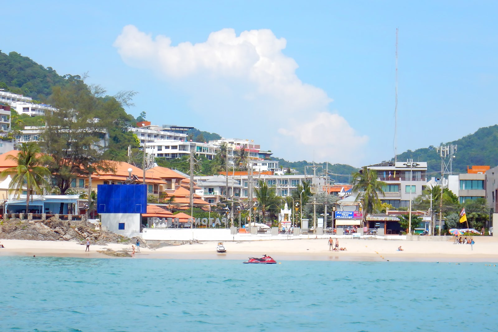 The popular Patong Beach with tourists doing various activities
