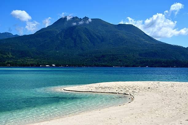 Camiguin island clear water and white sand beach with mountain view