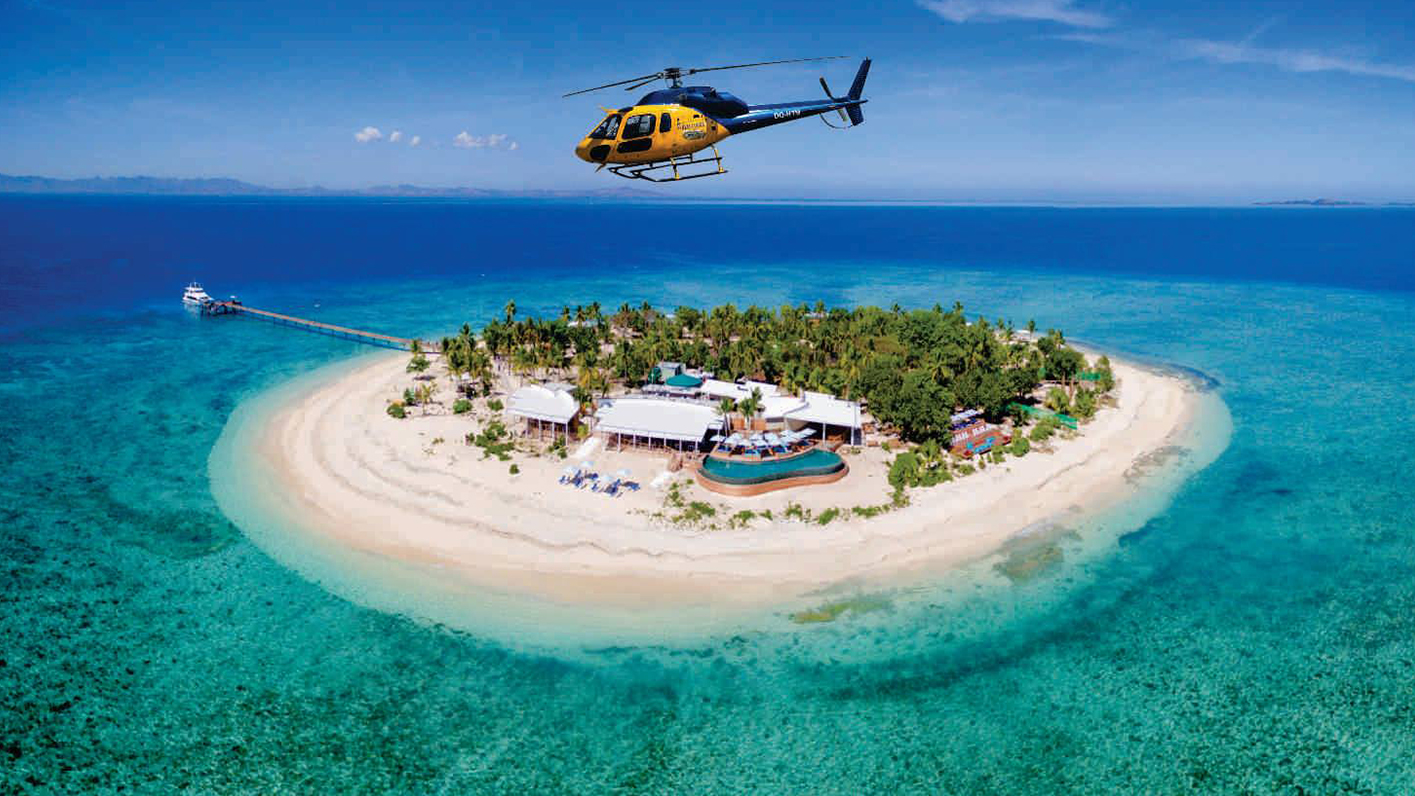 A helicopter passing by Mamanuca Islands