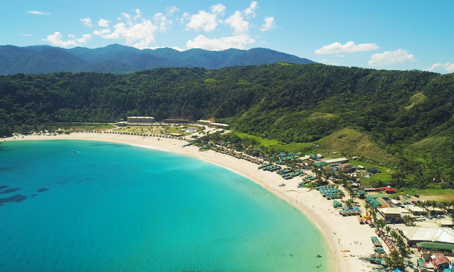 Pagudpud beach aerial view with blue sea water and different resorts along side the beach