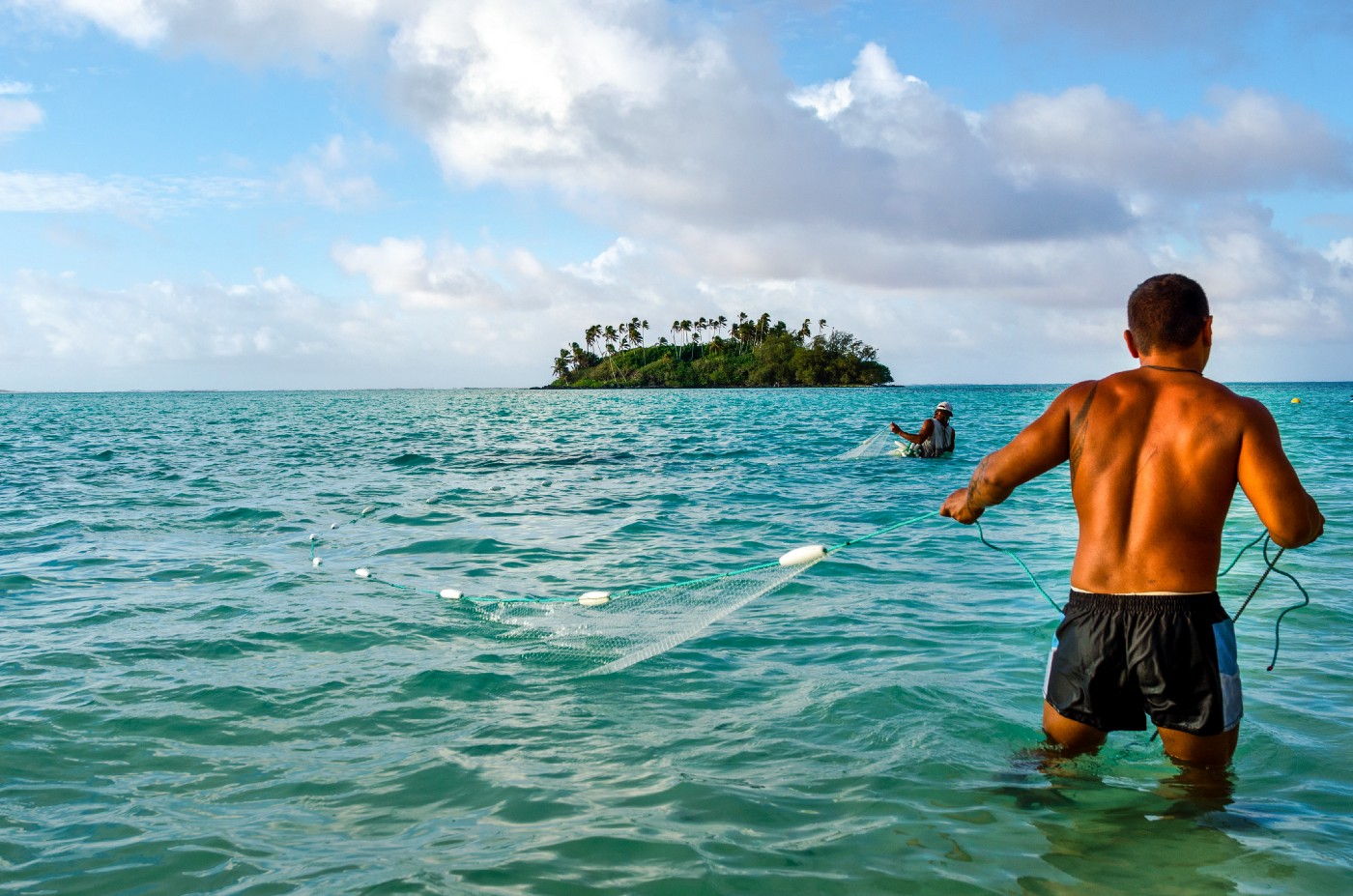 Cook islanders fishing in the ocean during summer time