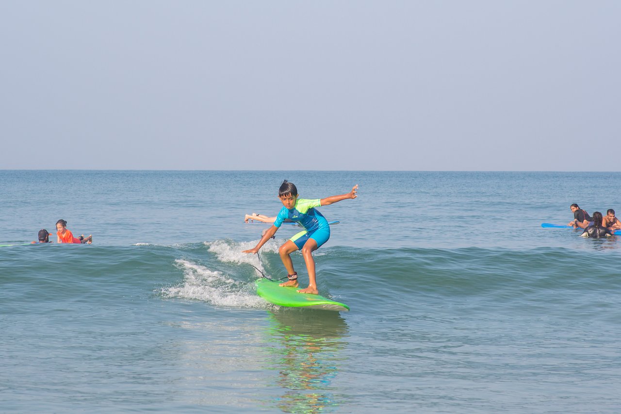 A Child Surfing At Agonda