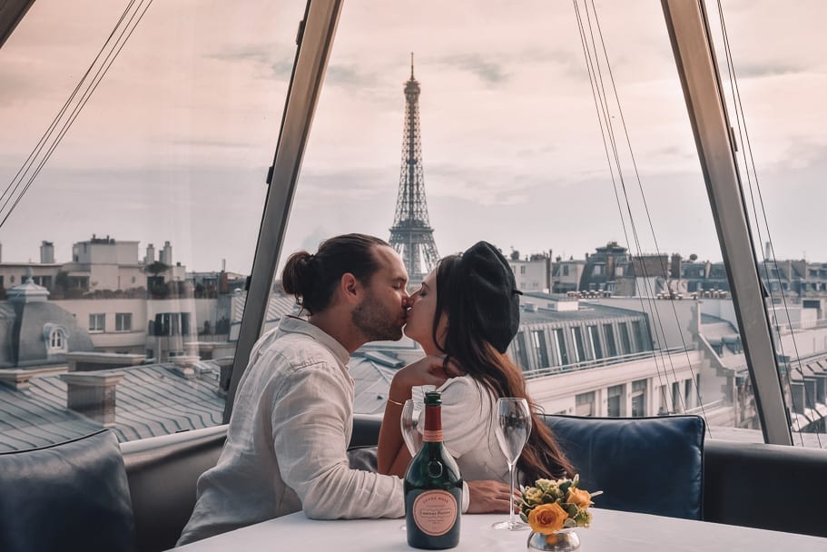 A couple kissing with Eiffel tower in the backdrop