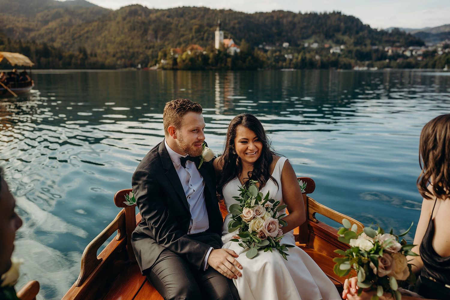 A newly wed couple riding a boat on Lake Bled