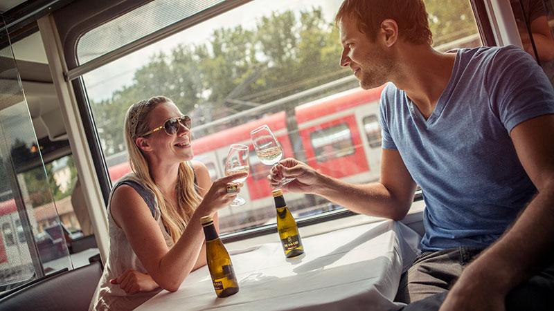 A couple drinking during a train ride