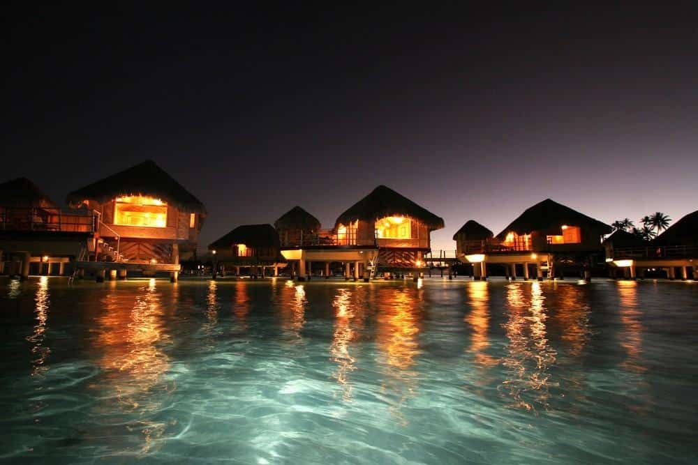 Lighted villas in the water in Taha’a, French Polynesia