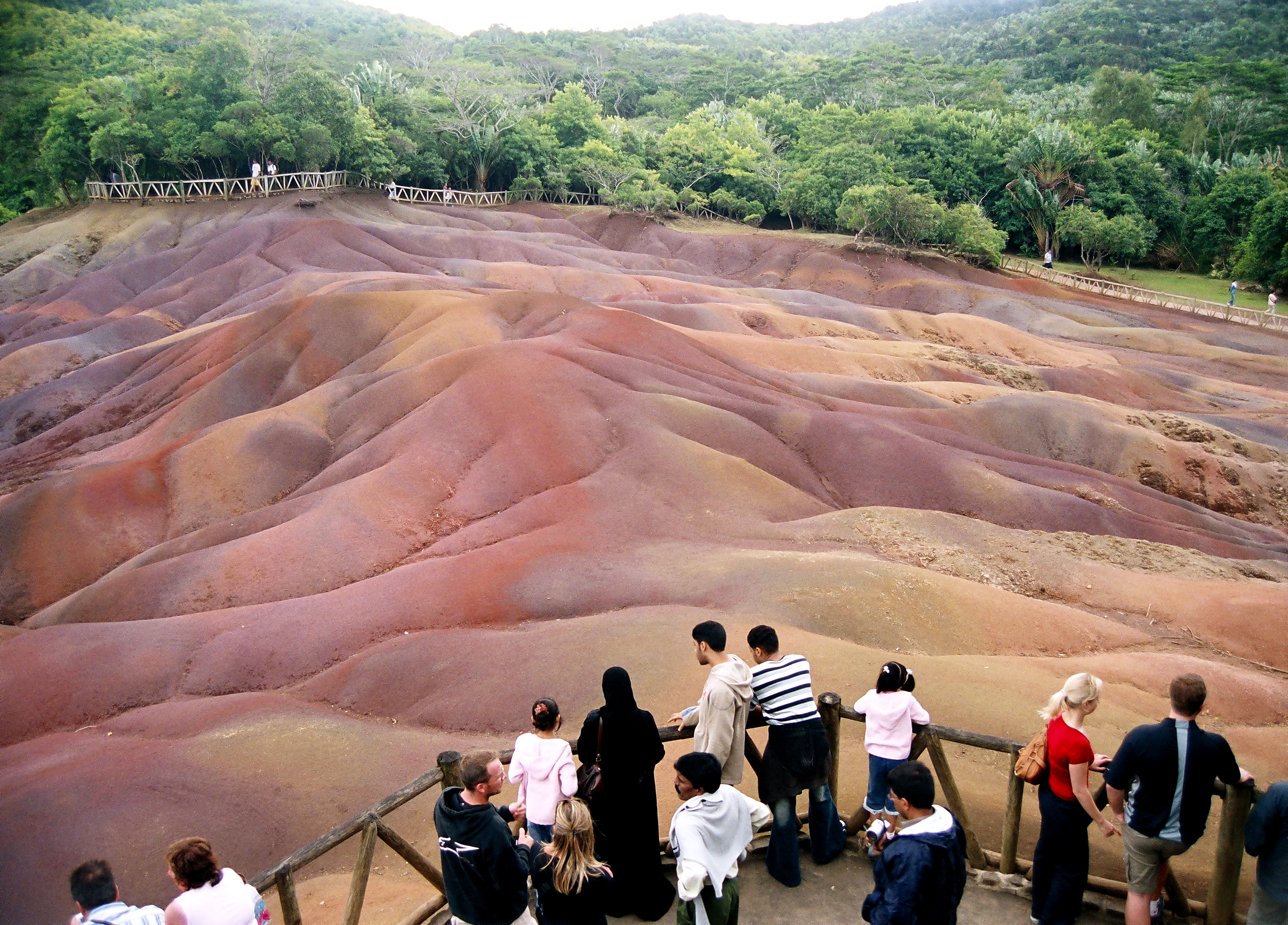 Some tourists at Chamarel seven colored sand
