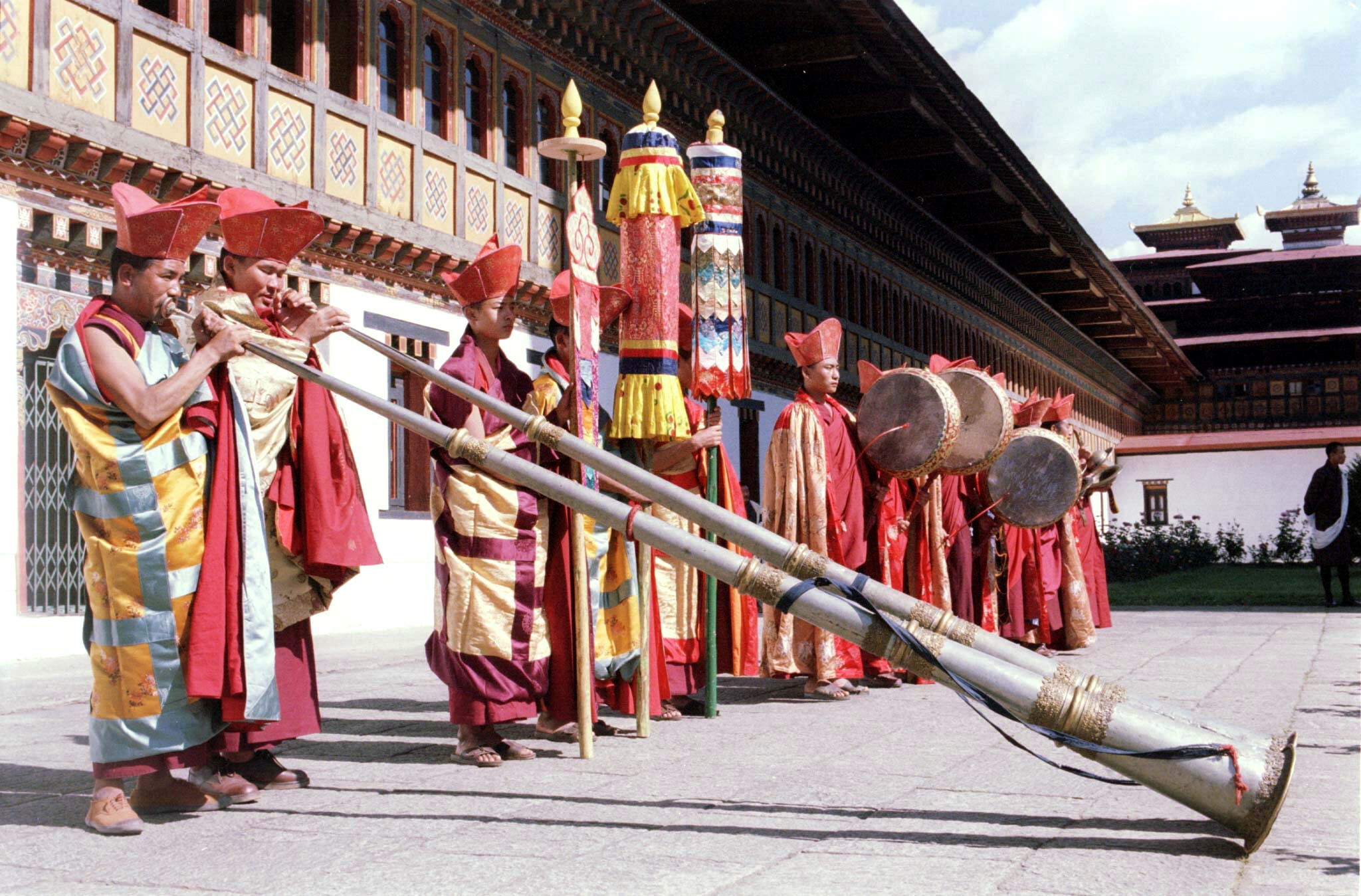 Some Bhutanese men blowing their traditional horns