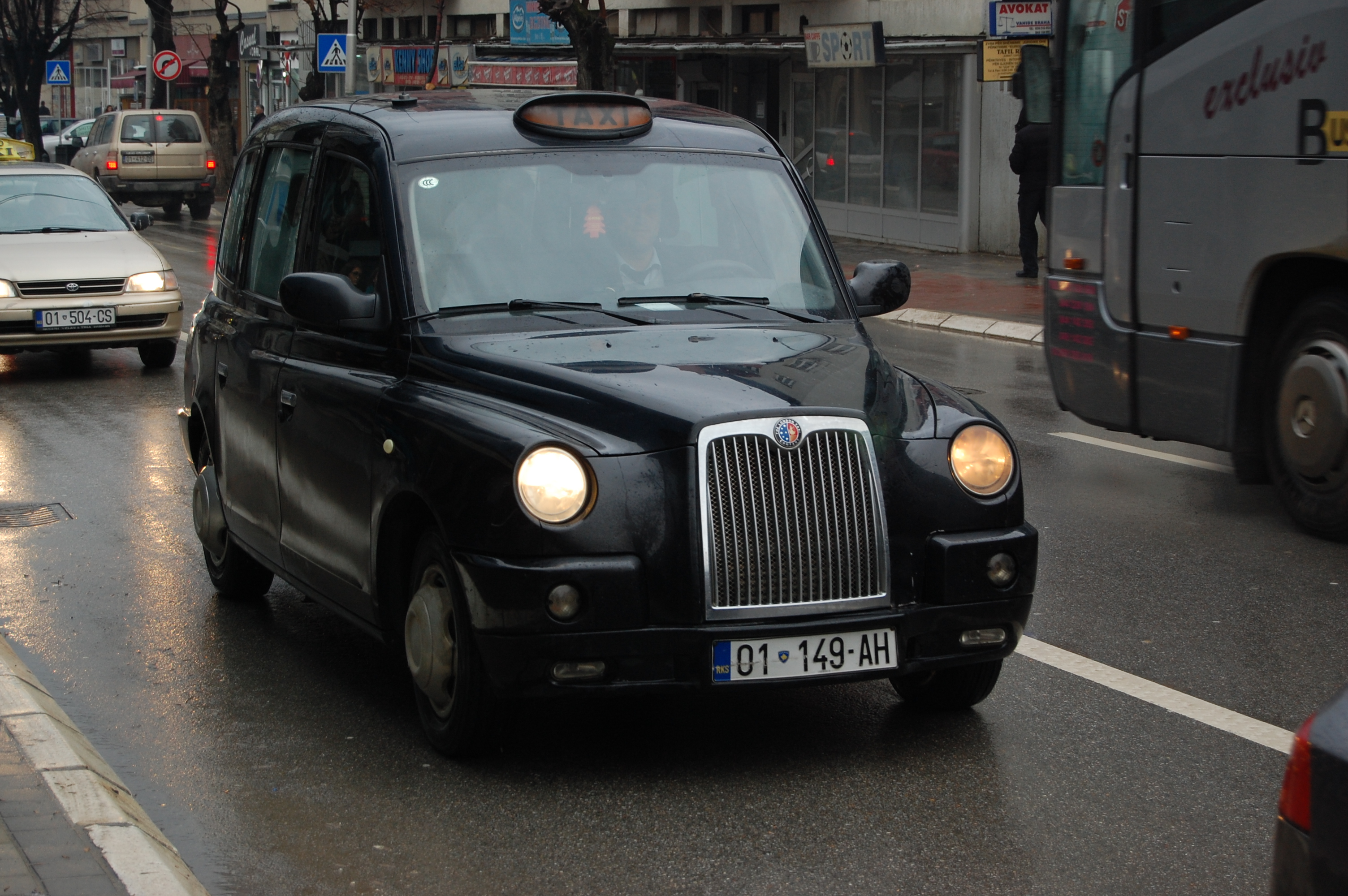 A black cab driver on the road driving in London
