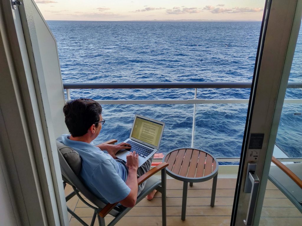 A man with his laptop in a cruise ship