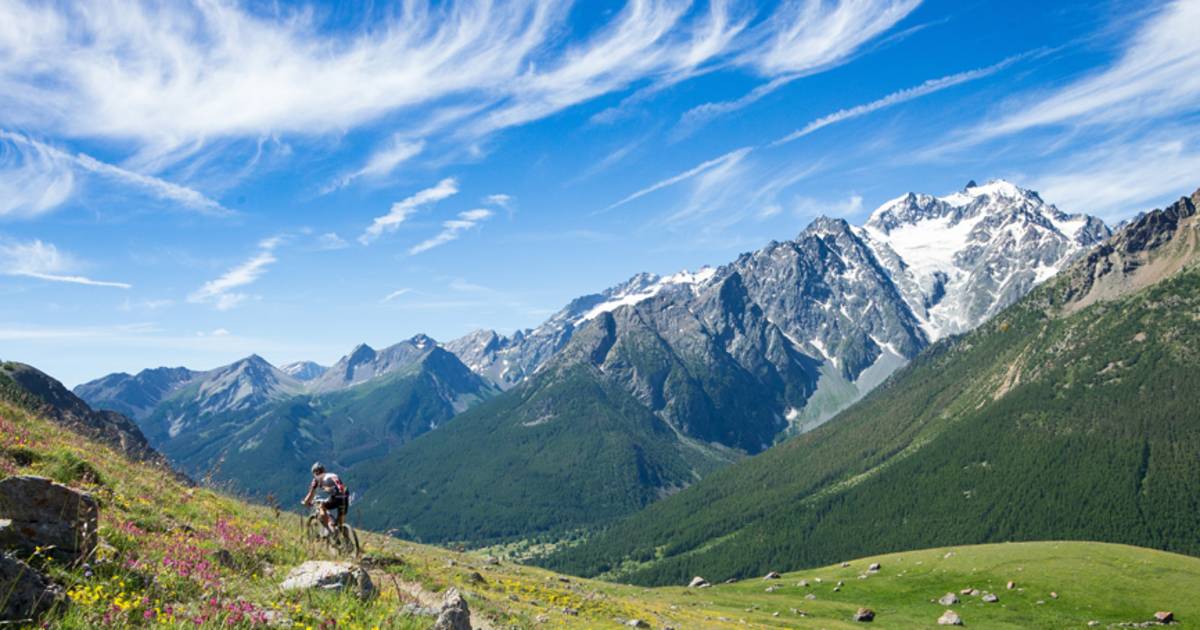 A man biking near the Alps