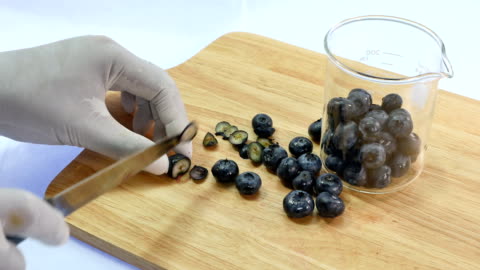 Man cutting blueberries into smaller pieces