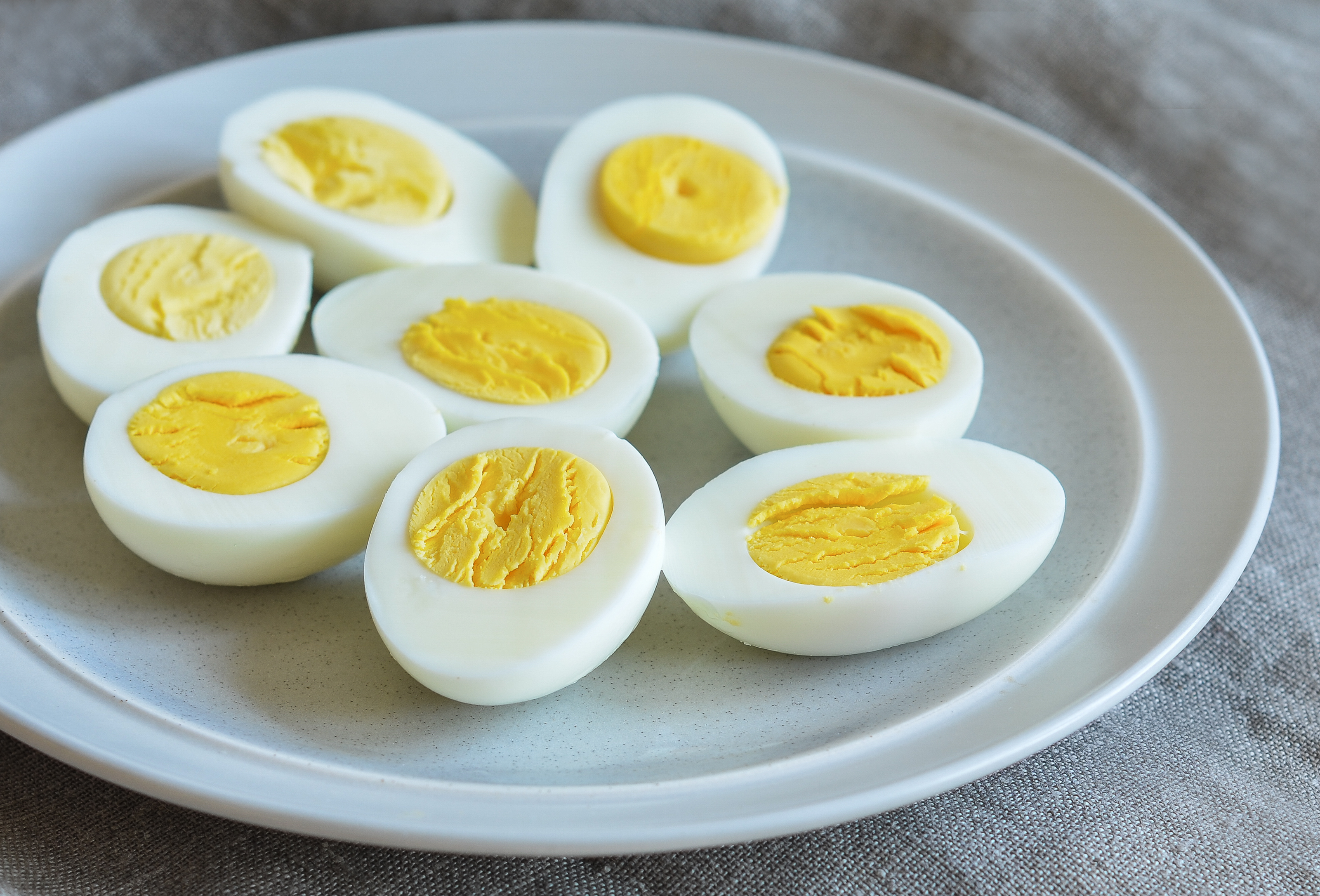 Several slice boiled eggs on a plate