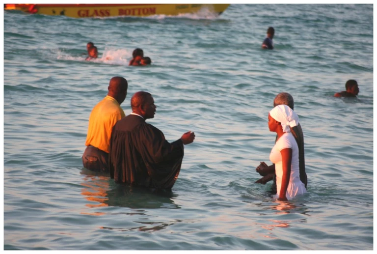 People getting baptised on the beach